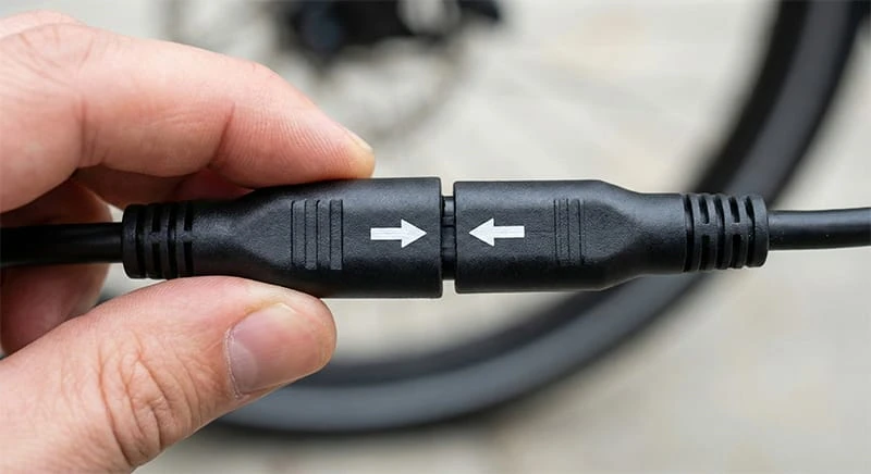 Close up showing the arrow alignment on an ebike motor cable connector.